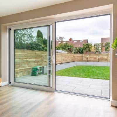 Internal photograph of a white lift and slide patio door installed by alexander windows