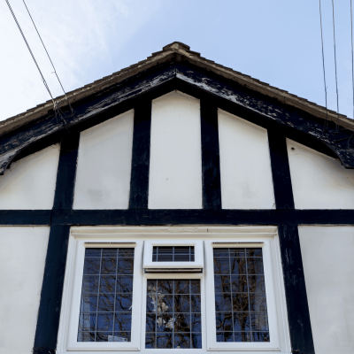 close up view of a kommerling window in white with square lead glass installed at davenport residential home in stockport