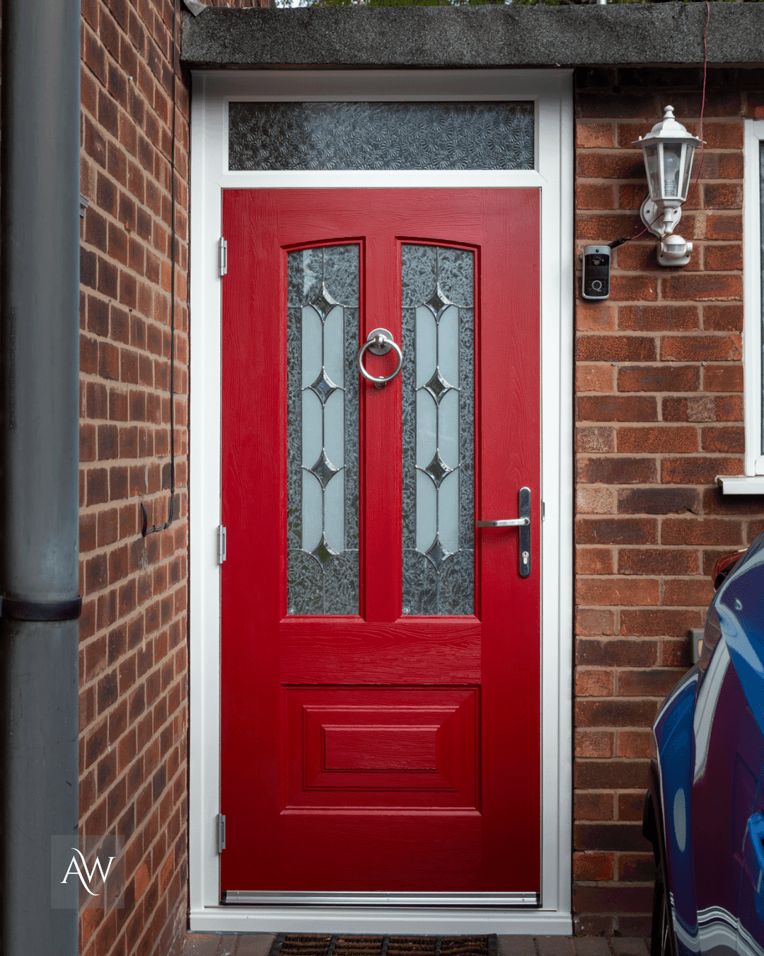 rockdoor composite door in ruby red with a white frame and kudos glass installed at a detached property in Sale by Alexander Windows