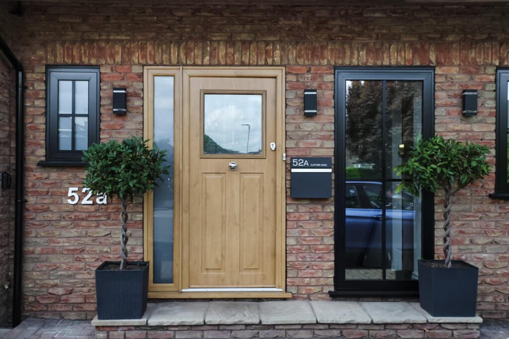 Exterior view of black aluminium flush casement windows & solidor composite door