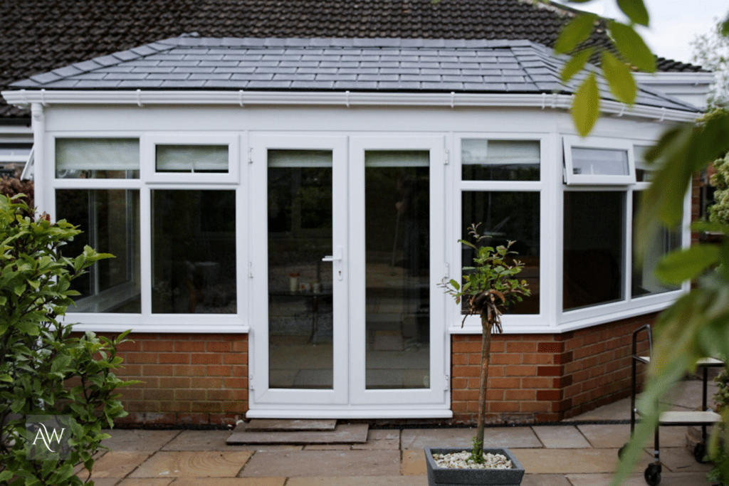 Conservatory with a Guardian Warm Roof & frames installed by Alexander Windows. Photograph in an external view.