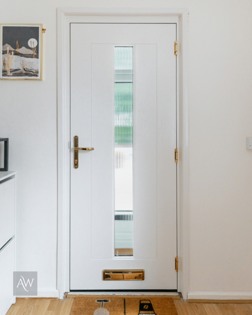 Installation by alexander windows of a rockdoor hudson composite door. Photograph showing the inside of the door which is white with white frame and gold furniture.