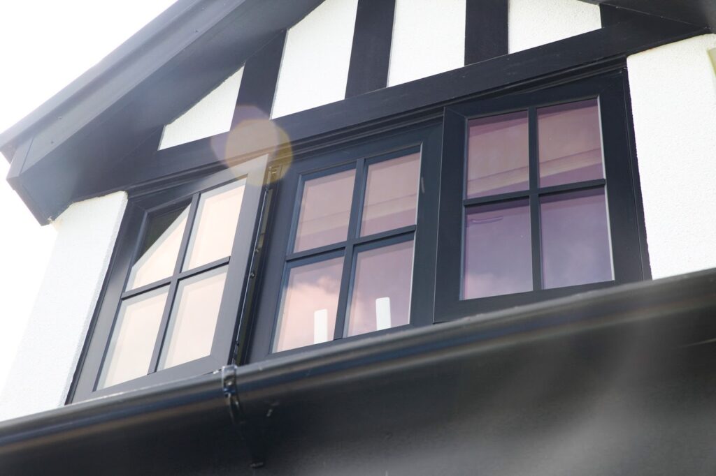 exterior photograph of flush black aluminium windows installed by alexander windows in poynton